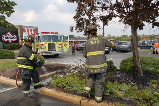 FF/EMT DiPrima and Lt. Bennett handle a brush fire at TGIF's while Ex-Chief Stewart pumps, August 2009.